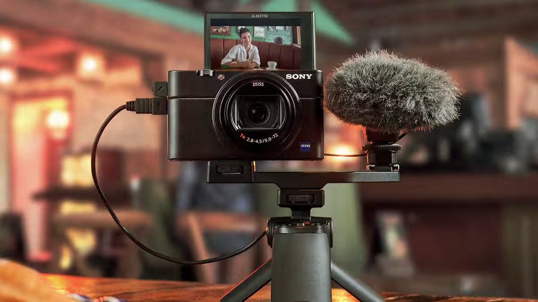 Sony's RX100 VII is shown with the screen flipped up and mounted on a small tripod.